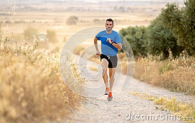 Man running at sunset on country road lane. Stock Photo