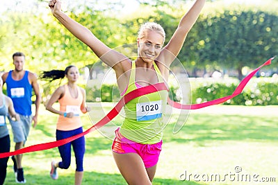 Happy young female runner on finish winning race Stock Photo