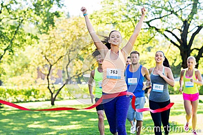 Happy young female runner on finish winning race Stock Photo
