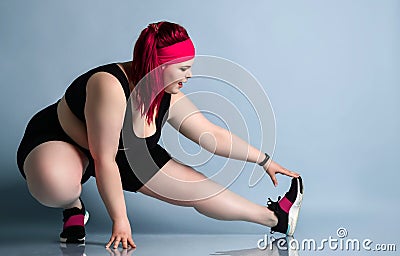 Fitness spring diet weight loss concept. Lucky plus-size girl overweight woman dieting working out doing stretching exercises Stock Photo