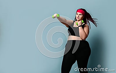 Fitness spring diet weight loss concept. Lucky plus-size girl overweight woman dieting working out with green weights dumbbells Stock Photo