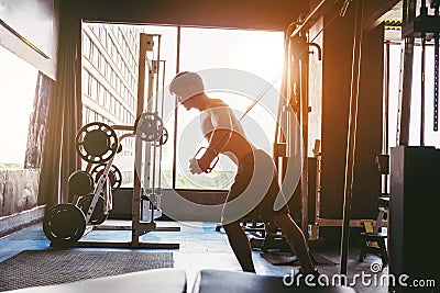 Fitness Strong Man Doing Heavy Weight Exercise on Machine in gym Stock Photo