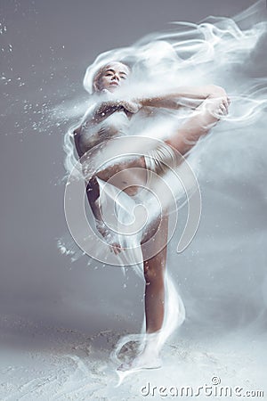 Fitness woman dancer in dust / fog Stock Photo