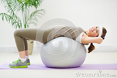 Fitness woman doing abdominal crunch on ball Stock Photo