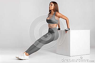 Fitness woman doing push-ups, working out. Athletic girl training Stock Photo