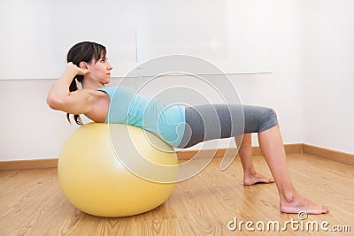 Fitness woman in gym on pilates ball. Young woman doing exercise on fitness ball. Stock Photo