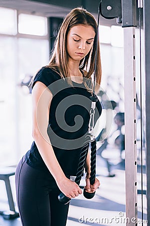 Fitness woman in the gym. Young woman doing fitness exercises in the gym, with lot machine Stock Photo