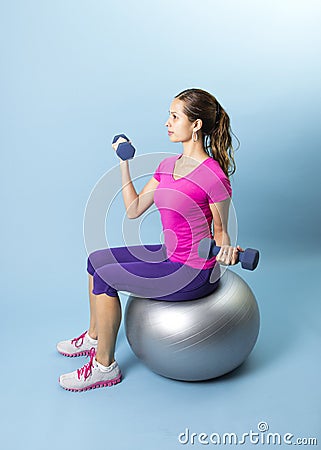 Fitness Woman lifting Weights on a medicine ball Stock Photo