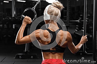 Fitness woman with muscular back in gym. Athletic girl working out Stock Photo