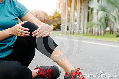 Fitness woman runner feel pain on knee. Outdoor exercise activities concept Stock Photo