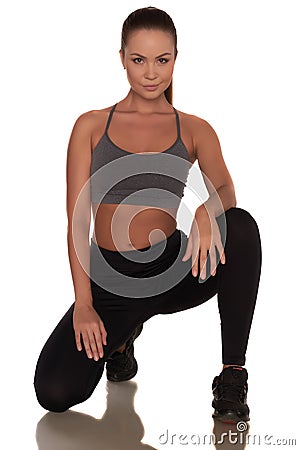 Fitness woman in sport style standing against isolated white background Stock Photo