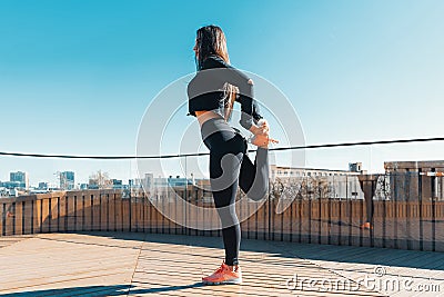 Fitness woman stretching and exercising outdoors in urban environment. Stock Photo