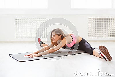 Fitness woman at stretching training indoors Stock Photo