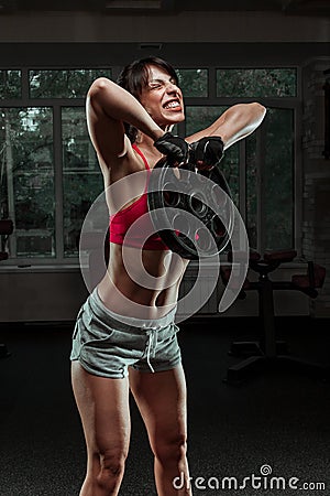 Fitness woman swinging kettle bell at gym Stock Photo