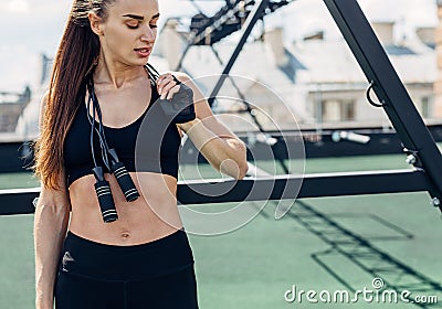 Fitness woman taking a break standing with jumping rope Stock Photo