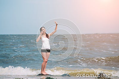 Fitness women exercising and stretching on the seacoast and making selfie Stock Photo