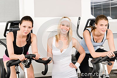 Fitness young girls spinning at gym posing Stock Photo