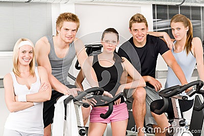 Fitness young group people at gym bicycle Stock Photo