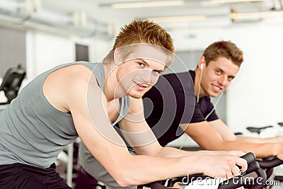 Fitness young man on gym bike spinning Stock Photo