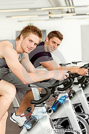 Fitness young man on gym bike spinning Stock Photo