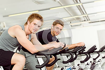 Fitness young man on gym bike spinning Stock Photo