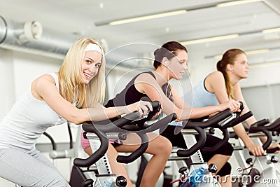 Fitness young woman on gym bike spinning Stock Photo