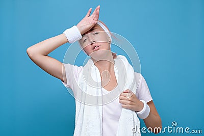 Fitness young woman with her hand on head sweating. Stock Photo