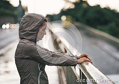 Fitness young woman in rainy city Stock Photo