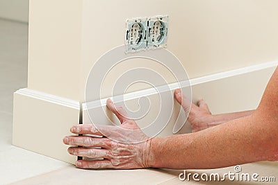 Fitting the baseboard Stock Photo