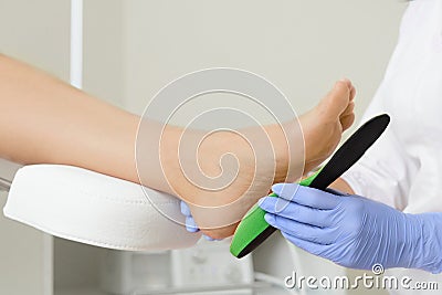 Fitting orthotic insoles. Stock Photo