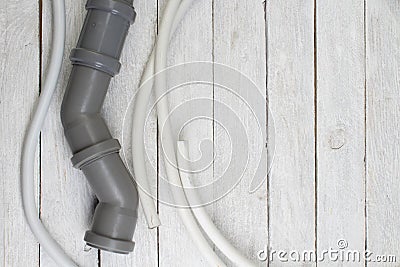 Fittings, pipe, valves, plastic pipe for water, adjustable wrench on the wooden background. Top view. Copy space for text Stock Photo