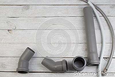Fittings, pipe, valves, plastic pipe for water, water hose, adjustable wrench on the wooden background. Top view. Copy Stock Photo