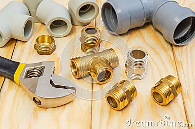 Fittings and spare parts, accessories for plumbing repair on a wooden boards Stock Photo