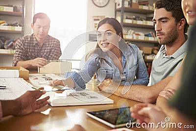 Five Architects Sitting Around Table Having Meeting Stock Photo