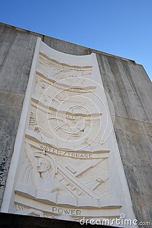 The five bas-reliefs on the Nevada elevator tower, done in concrete, show the multipurpose benefits of Hoover Dam: flood control, Editorial Stock Photo