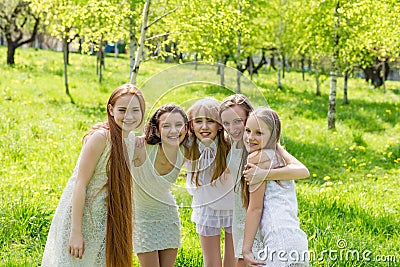 Five beautiful young girls in white dresses in summer Stock Photo