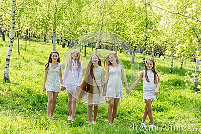 Five beautiful young girls in white dresses in summer Stock Photo