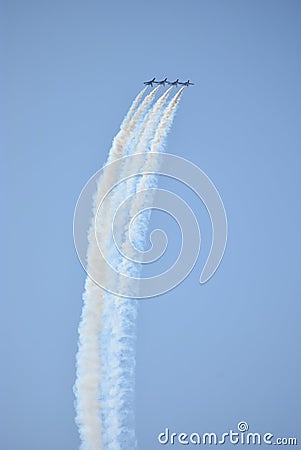 Five blue angel jets flying up with colorful smoke trails Stock Photo