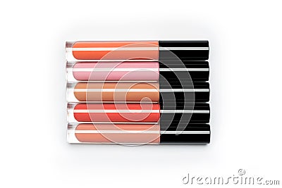 Five brightly coloured bottles of liquid lipstick and lip gloss Stock Photo