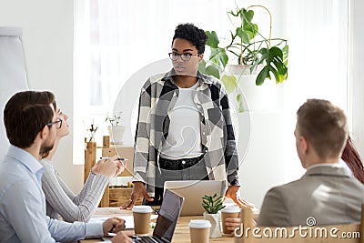 Five businesspeople sitting at seminar in conference room Stock Photo