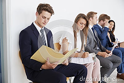 Five candidates sit waiting for job interviews, close up Stock Photo