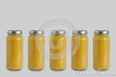 Five cans of canned apple puree in glass jar on gray background Stock Photo