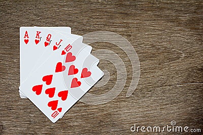 Five card of red heart royal straight flush on wood background Stock Photo