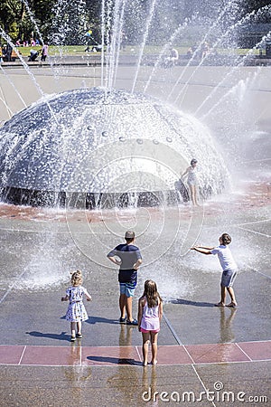 Five Children looking at and Playing in Seattle Fountain Editorial Stock Photo