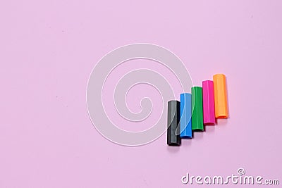 Five colorful pen cap on a pink millennial background. Space to insert the text. Office stuff. Minimalism. Stock Photo