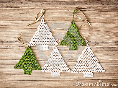 Five crochet christmas trees on the wooden background Stock Photo