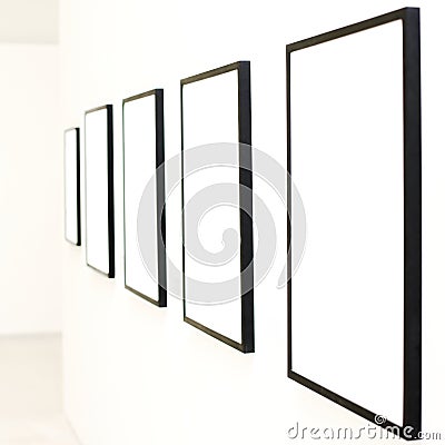 Five empty frames on white wall exhibition Stock Photo