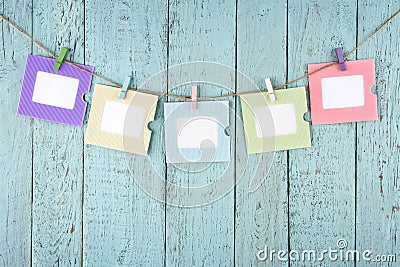 Five empty photo frames hanging with clothespins Stock Photo