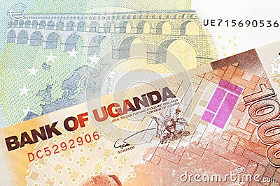 Ugandan currency paired with money from Europe Stock Photo