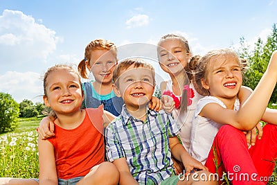 Five funny kids on a meadow Stock Photo